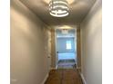 Bright hallway featuring modern lighting fixtures with freshly painted walls at 316 Olivia Crossing Ct # 11, Four Oaks, NC 27524