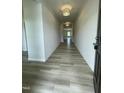 Long hallway with hardwood flooring, neutral walls, and modern lighting fixtures at 316 Olivia Crossing Ct # 11, Four Oaks, NC 27524