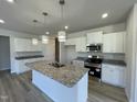 Modern kitchen with white cabinets, granite countertops, stainless steel appliances and a central island at 316 Olivia Crossing Ct # 11, Four Oaks, NC 27524