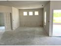 Unfinished living room with decorative molding, large windows, and an open floor plan, ready for customization at 316 Olivia Crossing Ct # 11, Four Oaks, NC 27524