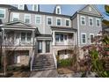 Lovely townhome featuring a covered porch and well-manicured landscaping at 322 Clementine Dr, Cary, NC 27519