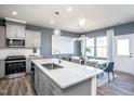 Well-designed kitchen featuring a stylish island, modern appliances, and an adjacent dining space at 3404 Pelican Ln, Durham, NC 27703