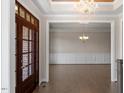 Elegant foyer showcases a coffered ceiling, hardwood floors, and decorative lighting fixture at 4009 Banks Stone Dr, Raleigh, NC 27603