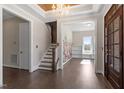 Spacious foyer boasts hardwood floors, stairs and decorative wall accents with large windows at 4009 Banks Stone Dr, Raleigh, NC 27603