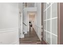 Bright foyer with hardwood floors, white trim, and staircase with a view of the living area at 501 Historic Dr, Hillsborough, NC 27278