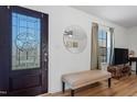 Inviting entryway with decorative glass door, round mirror, and bench at 506 W Gilbreath St, Graham, NC 27253
