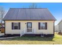 Charming home features a new metal roof and yellow siding at 506 W Gilbreath St, Graham, NC 27253