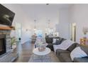 Inviting living room with a stone fireplace, ample seating, and bright, open layout at 5171 S River Rd, Lillington, NC 27546