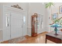 Bright foyer with hardwood floors, high ceilings, and a classic grandfather clock at 5309 Shoreline Ct, Holly Springs, NC 27540