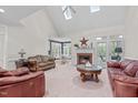 Spacious living room with vaulted ceilings, fireplace, and access to outdoor patio at 5309 Shoreline Ct, Holly Springs, NC 27540