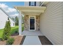 Home entrance featuring stone accents and well-manicured landscaping at 542 Winding Crk Dr, Lillington, NC 27546