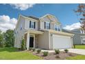 Two-story home featuring a two-car garage, stone accents and manicured lawn at 542 Winding Crk Dr, Lillington, NC 27546
