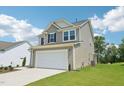 Two-story home featuring a two-car garage and well-maintained lawn at 542 Winding Crk Dr, Lillington, NC 27546
