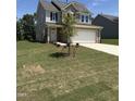 Two-story home with a well-manicured lawn, complemented by a two-car garage and inviting gray siding at 542 Winding Crk Dr, Lillington, NC 27546