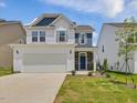 Charming home boasting white siding, stone accents, and a two-car garage at 542 Winding Crk Dr, Lillington, NC 27546