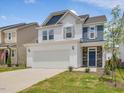 Beautiful two-story home with white siding, stone accents, and a two-car garage at 542 Winding Crk Dr, Lillington, NC 27546