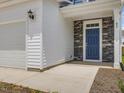 Stylish entryway showcases a blue front door with stone accents and a two-car garage at 542 Winding Crk Dr, Lillington, NC 27546