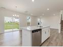 Bright, modern kitchen features a center island, stainless steel dishwasher, and sleek countertops at 542 Winding Crk Dr, Lillington, NC 27546