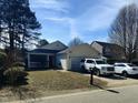 Charming single-story home with a screen porch, attached garage, and well-maintained front yard and driveway at 5836 Bryanstone Pl, Raleigh, NC 27610