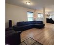 Spacious open-concept living area with modern light fixtures, and plenty of natural light from the large window at 5836 Bryanstone Pl, Raleigh, NC 27610