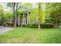 Brick home with a two car garage and white pillars at the front entrance at 826 Warwick Ct, Burlington, NC 27215