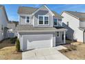 Charming two-story home with gray siding, a two-car garage, and manicured landscaping at 88 Antler Steel Dr, Clayton, NC 27527