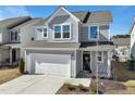 Charming two-story home with gray siding, a two-car garage, and manicured landscaping at 88 Antler Steel Dr, Clayton, NC 27527