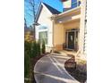 Inviting front entrance features a curved walkway, stone accents, and charming decor for a welcoming approach at 98102 Drummond, Chapel Hill, NC 27517
