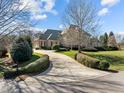 Long driveway to the garage, with mature landscaping and greenery on either side at 1017 Payton Ct, Raleigh, NC 27614