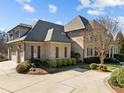 Attached two car garage with brick veneer, and an attached living space above at 1017 Payton Ct, Raleigh, NC 27614