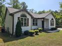 Beautiful house with neutral siding, landscaped with green shrubs, complemented by an immaculate front yard at 1212 E Middleton Dr, Creedmoor, NC 27522