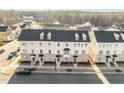 Aerial view of townhomes showcasing their brick facade, black roofs, and neatly landscaped surroundings at 1414 Excelsior Grand Ave, Durham, NC 27713