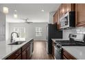 Open kitchen featuring stainless appliances, a center island, and seamless transition to the living area at 1414 Excelsior Grand Ave, Durham, NC 27713