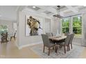 Bright dining room featuring a coffered ceiling, a modern chandelier, a large window, and an accent wall at 143 Sugar Pine Drive, Franklinton, NC 27525