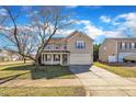 Inviting two-story home with a paved driveway, lush lawn, and a charming, blossoming tree at 148 Brockton Ridge Dr, Garner, NC 27529