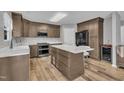 Modern kitchen with wood cabinets, stainless steel appliances, and a marble countertop island at 148 Brockton Ridge Dr, Garner, NC 27529
