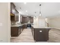 Modern kitchen with an island, stainless steel appliances, granite countertops, and ample dark wood cabinetry at 1987 Meadowview Dr, Graham, NC 27253