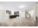 Bright, open-concept living room and kitchen space with hardwood floors, neutral paint and lots of natural light at 1987 Meadowview Dr, Graham, NC 27253