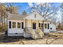 Charming home with a inviting porch, concrete steps, and classic black shutters at 2504 E East Geer St, Durham, NC 27704