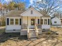 Inviting home features a quaint porch, updated concrete stairs, and well-lit windows at 2504 E East Geer St, Durham, NC 27704
