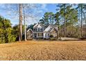 Inviting two-story home with stone accents, black shutters, and a well-manicured front yard at 2600 Buckingham Dr, Sanford, NC 27330