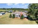 Charming home with large yard, mature trees, and outbuildings, exuding curb appeal at 2609 Pleasant Hill Liberty Rd, Liberty, NC 27298