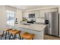 Stylish kitchen featuring granite countertops, stainless steel appliances, and a breakfast bar with seating at 261 Holton St, Smithfield, NC 27577