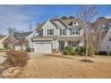 Charming two-story home features shingle siding, a two-car garage, and manicured landscaping at 2745 Cutleaf Dr, Apex, NC 27539