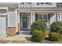 Inviting front porch features stone accents and manicured shrubs along the walkway at 2745 Cutleaf Dr, Apex, NC 27539