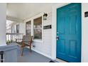Close-up of the front porch showing a blue front door, seating, and fresh paint at 302 St Augustine Ave, Raleigh, NC 27610