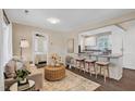 Stylish open-concept living room that flows to kitchen with bar stool seating at 302 St Augustine Ave, Raleigh, NC 27610