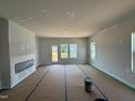 Unfinished light-filled living room with large windows and access to a patio at 304 Chesapeak Commons St # 146, Garner, NC 27529