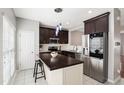 Bright kitchen with stainless steel appliances, kitchen island, and sleek countertops at 3118 Settle In Ln, Raleigh, NC 27614