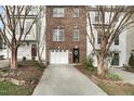 Brick townhouse with a one-car garage, front yard landscaping, and a welcoming front door at 3118 Settle In Ln, Raleigh, NC 27614